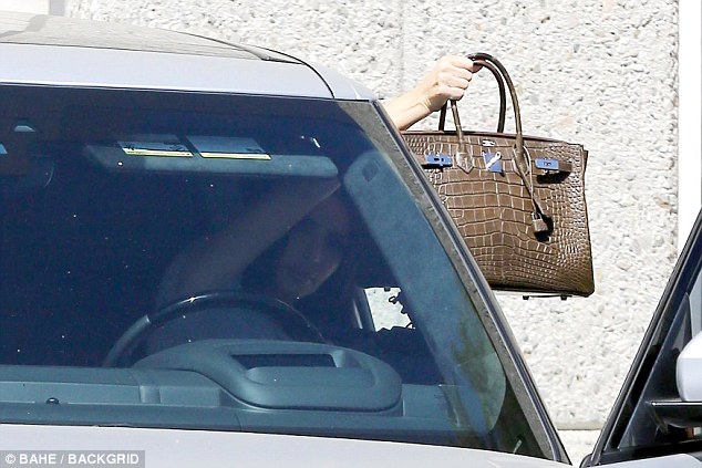 Kim Kardashian Covers Her Face With 0K Birkin Bag From Photographers Shortly After Kanye’s Rant