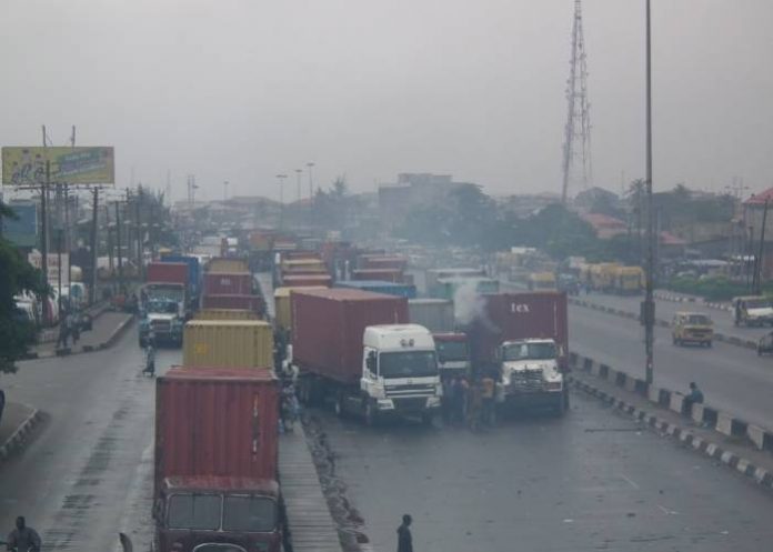 This picture taken on Tuesday, July 17, shows trucks completely blocking a section of the Oshodi-Apapa Expressway at Second Rainbow inward Mile 2, and commercial buses driving against traffic.