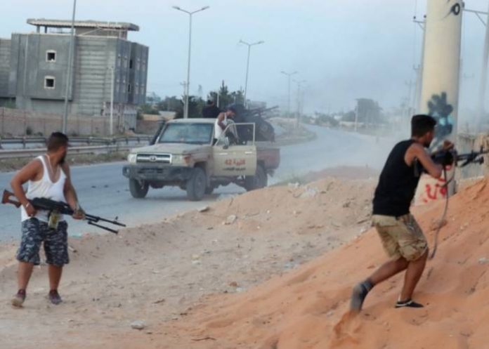 Fighting between a militia allied with Libya's internationally recognised government fight and two rival groups left some families trapped in their homes [Hani Amara-Reuters]