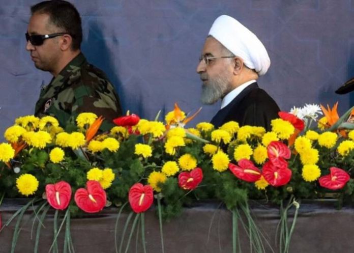 Iranian President Hassan Rouhani arrives to attend the annual military parade marking the anniversary of the outbreak of the devastating 1980-1988 war with Saddam Hussein's Iraq, in the capital Tehran on September 22, 2018.In Iran's southwestern city of Ahvaz during commemoration of the same event, dozens of people were killed with dozens others wounded in an attack targeting another army parade, state media reported on September 22. / AFP PHOTO / STRINGER