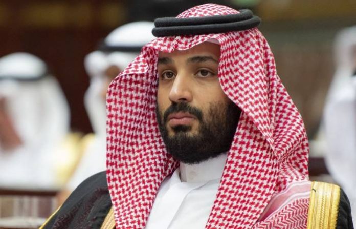 A handout picture provided by the Saudi Royal Palace on November 19, 2018, shows Saudi Arabia’s Crown Prince Mohammed bin Salman attending a speech given by his father, King Salman bin Abdulaziz while addressing the Shura council, a top advisory body, in the capital Riyadh. (Photo by Bandar AL-JALOUD / Saudi Royal Palace / AFP) /